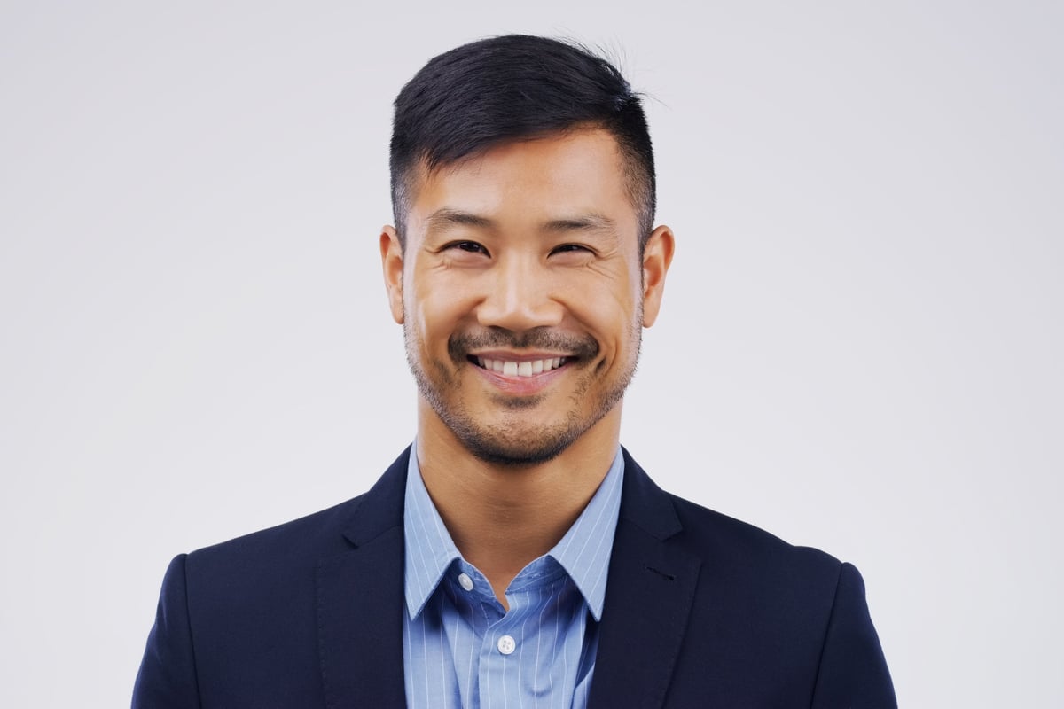 Studio portrait of a handsome young man posing against a grey background