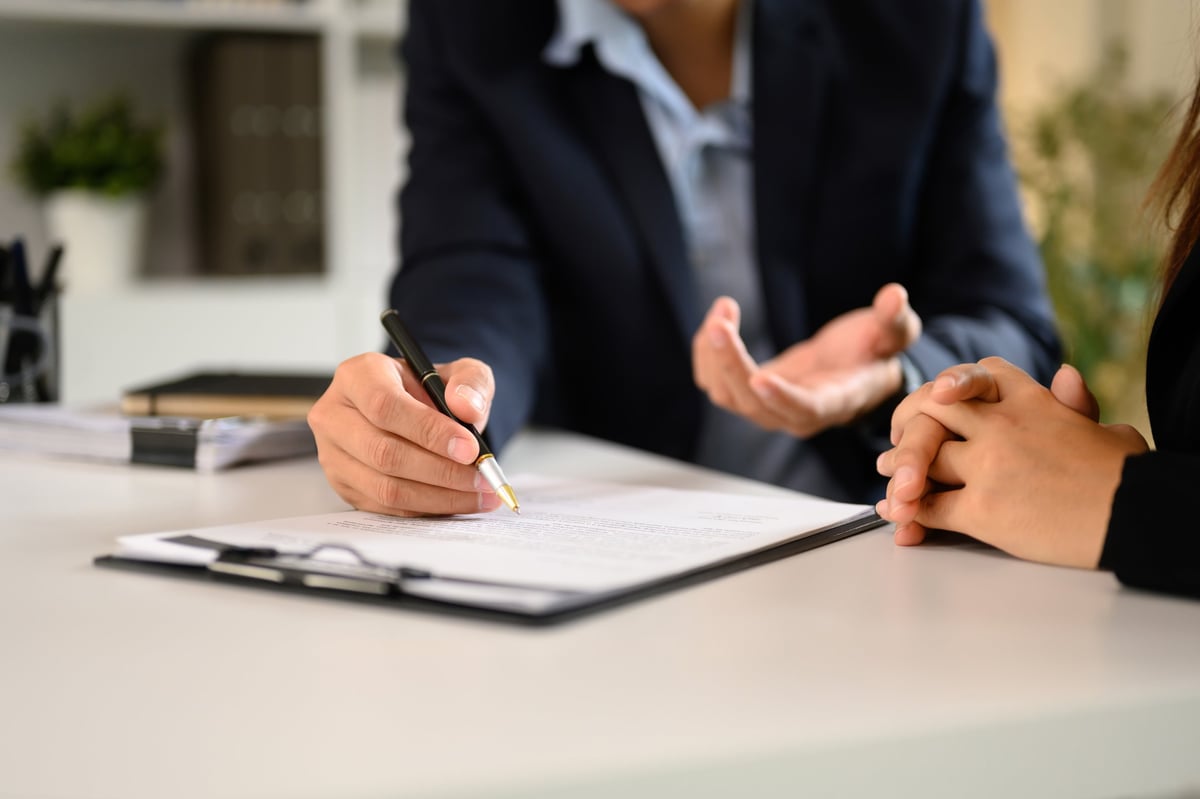 Two businesspeople in suits finalizing an important case at a modern office desk, professional consultation