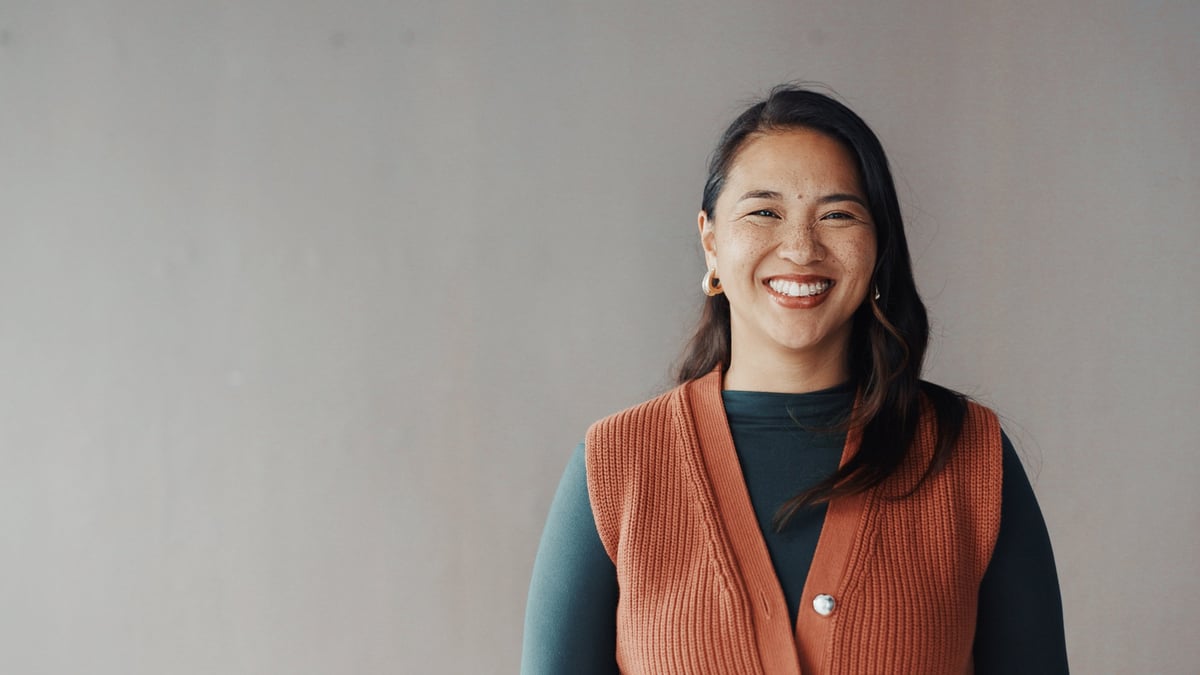 Portrait of a businesswoman smiling on gray background